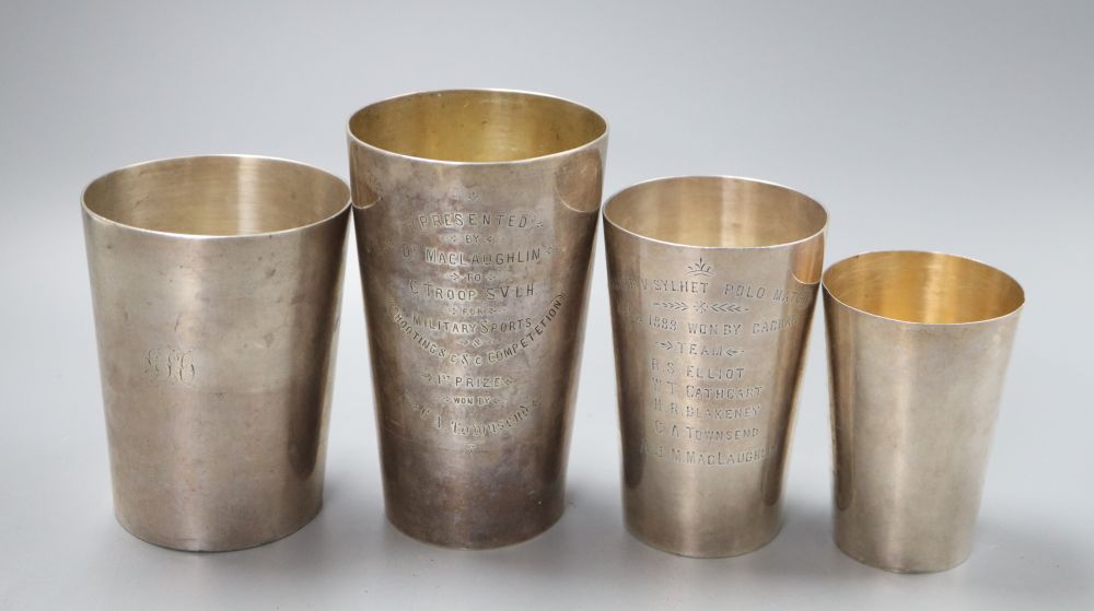 Three 19th century Indian white metal tumbler cups, retailers Grish C.Dutt of Calcutta (2) and Allan & Hayes, and another plain tumble